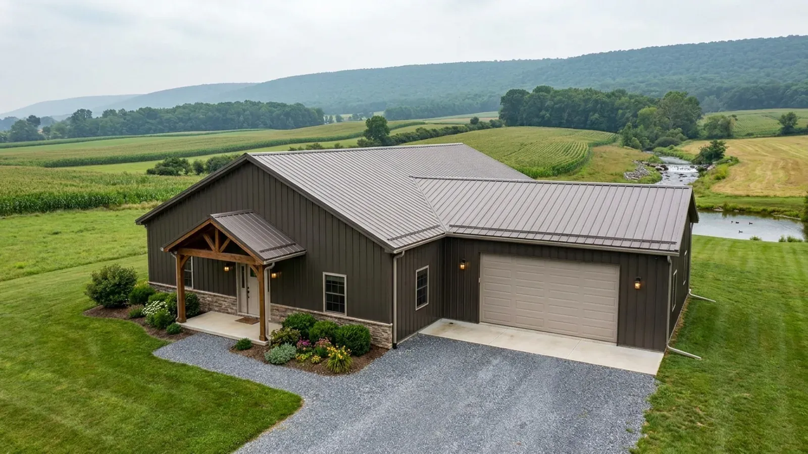 A completed 40x60 barndominium showing a residential entry on one end and a wide shop door on the other under one continuous roof.